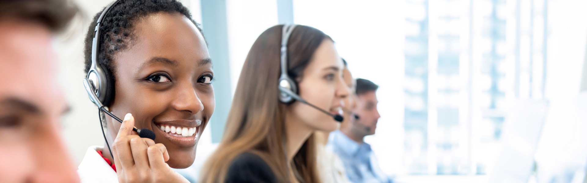 A diverse team of professionals working in a call center, providing assistance for USA Cash Services.