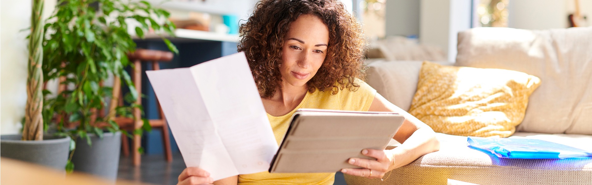 A woman sitting on the floor with a laptop, applying for an Online Payday Loan or Cash Advance Now.