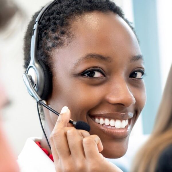 A smiling woman wearing a headset, representing customer service for USA Cash Services.