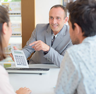 A man in a gray suit presenting Installment Loans plan to clients