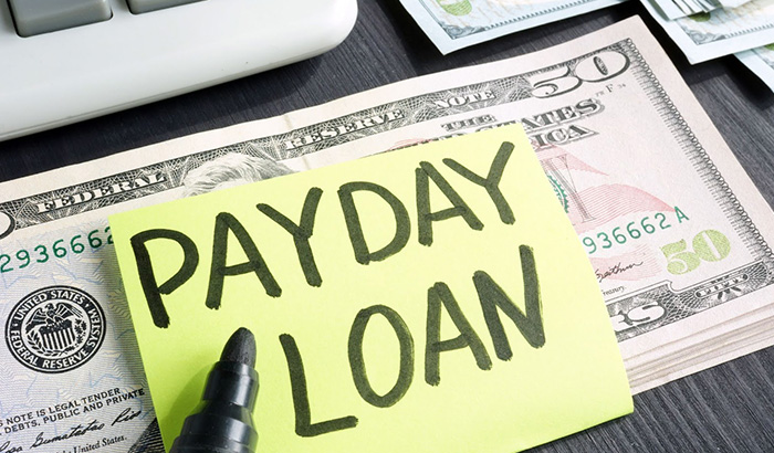 A payday loan with cash and calculator, symbolizing online payday loans and financial health