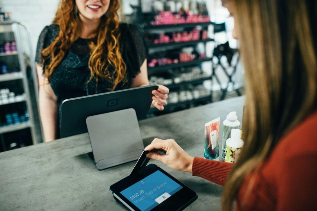 A woman completes a payment on a tablet, demonstrating tech convenience in transactions