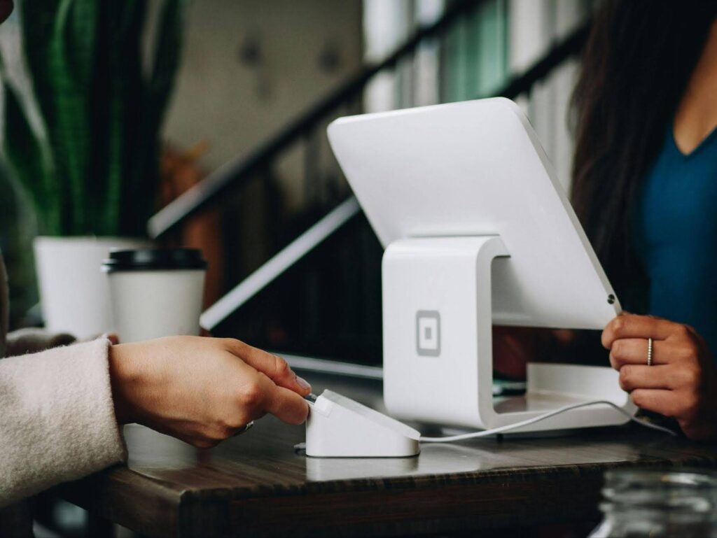 A woman uses a tablet for a digital payment