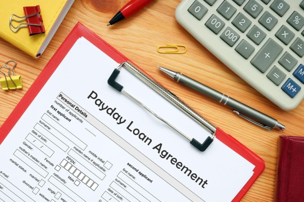 A Payday Loan Agreement form on a clipboard