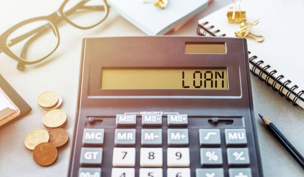A calculator displaying the word loan prominently on its screen indicating financial calculations